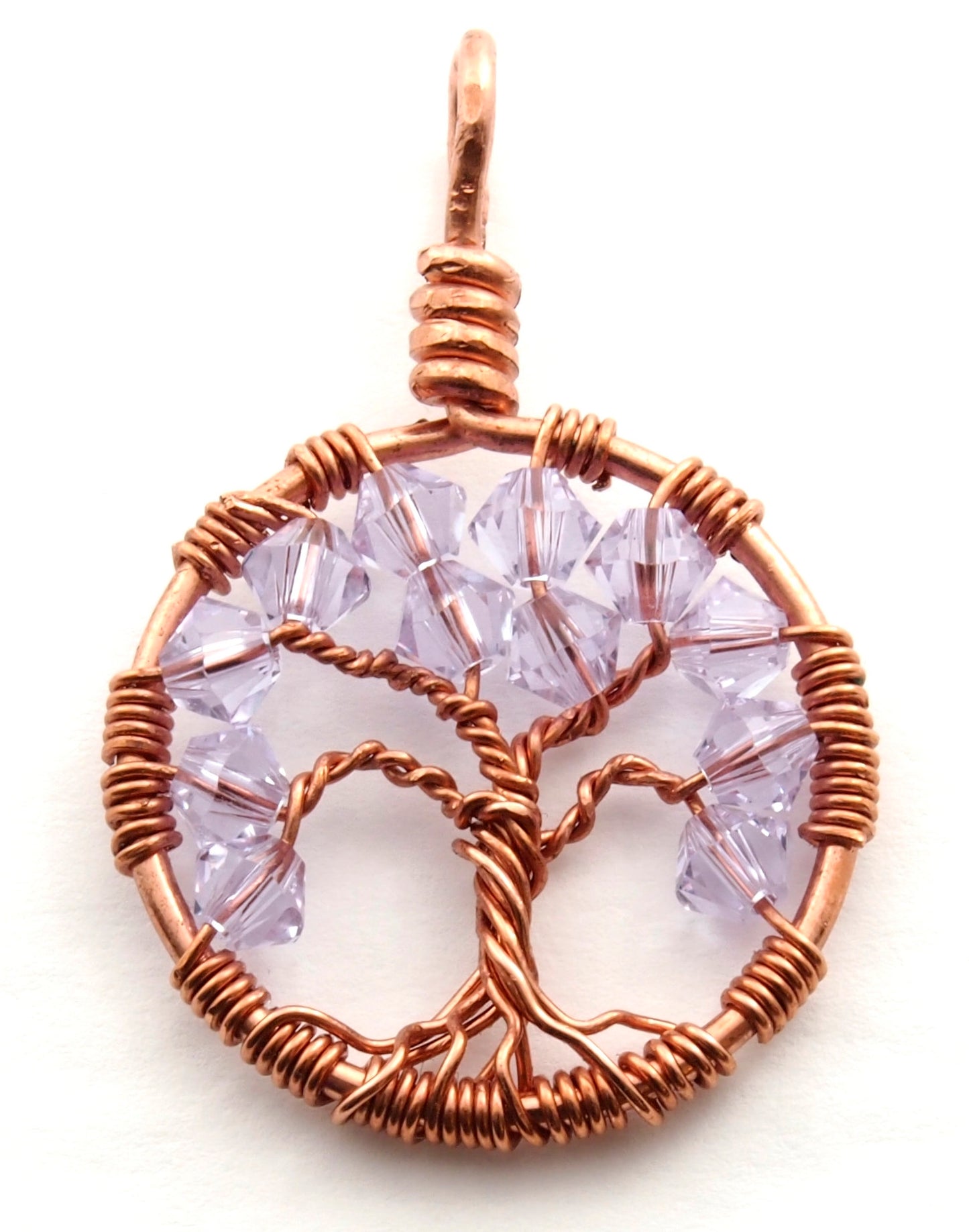 A close up image of the June birthstone tree of life pendant from Uncorked & Bottled Up made with Alexandrite Swarovski crystals and copper wire
