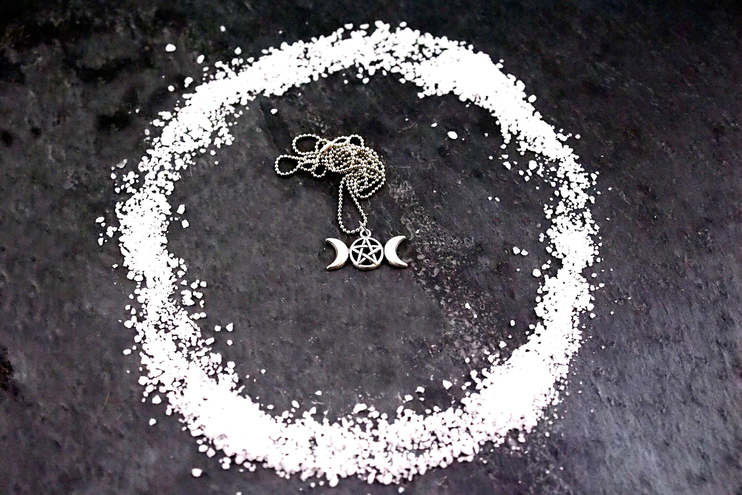 A styled image of the triple goddess pentagram necklace from Uncorked & Bottled Up